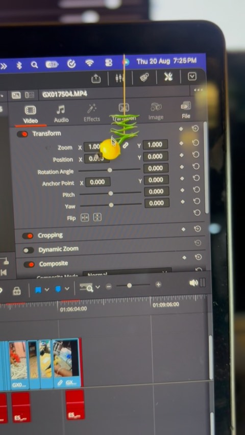 The lemon charm swaying over a video editing timeline