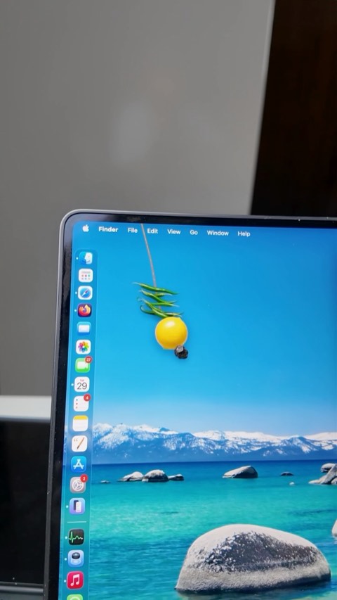 A lemon-and-chilies charm dangling over a Mac desktop